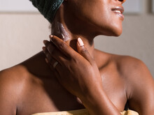 Crop Black Woman Applying Cream On Neck