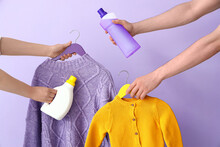 People With Bottles Of Laundry Detergent And Knitted Sweaters On Lilac Background