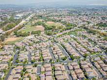 Irvine, California, USA – August 14, 2023: Top Drone View Toward Irvine Townhouses Townhomes Above Harvard Community Park Along With Jamboree Rd