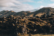 © Ivan Haidutski/Stocksy - Volcanic Mountains in Mossy Lava Field with Blue Cloudy Sky