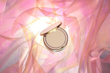 Cosmetic Powder Makeup On A Background Of Chiffon Fabric