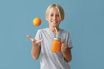 Sticker - Little boy with glass jar of juice and orange on blue background