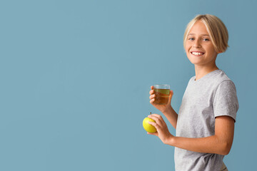 Sticker - Little boy with glass of juice and apple on blue background