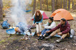 © Oleksii Syrotkin/Stocksy - Campfire camping fire food picnic firewood cookout together