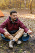© Oleksii Syrotkin/Stocksy - BBQ marshmallow skewer camping nature prepare