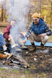 © Oleksii Syrotkin/Stocksy - Friendship emotion carefree campfire nature food cook