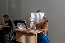 New Student In A Classroom Sitting At A Desk