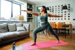© DZ FILM/Stocksy - A woman does yoga at home