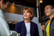 © Jovo Jovanovic/Stocksy - Three happy business people smiling and talking with each other