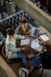 © Jovo Jovanovic/Stocksy - Business colleagues discussing in a meeting at cafe