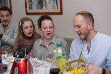 Four Siblings Celebrate Passover, Reading Haggadah, Singing Songs.