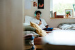 © BONNINSTUDIO/Stocksy - Man recording a podcast on bedroom