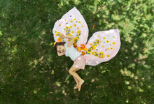 Fairy Tale Like Image Of Little Girl With Flower Butterfly Wings