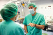 © VICTOR TORRES/Stocksy - Male surgeon with assistant in operating room