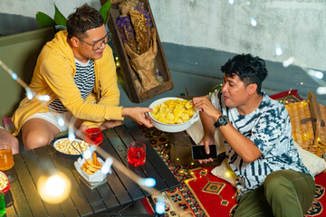 Diversity Asian millennial people friends enjoy dinner party with eating snack potato chip and soft drink at home outdoor rooftop for meeting reunion celebration holiday event new year with happiness 