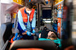© Raul Navarro/Stocksy - paramedic working on an ambulance