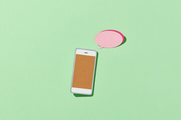 smartphone with speech text in dialogue balloon box on green