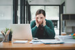 © Satori Studio - Tired businesswoman sleepy and bored from sitting at a desk for a long time and has office syndrome