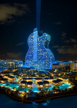 Aerial View Of Guitar Shaped Seminole Hard Rock Hotel And Casino Structure Illuminated With Bright Neon Colorful Lights In Hollywood, Florida