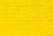 © Kristin Duvall/Stocksy - Brick wall painted yellow