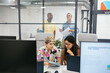 © Pedro Merino/Stocksy - Workers of a modern company reviewing data in a coworking office