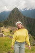 © Carlos Gonzales/Stocksy - Stylish young woman in Machu Picchu