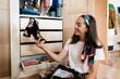 © Malquerida Studio/Stocksy - Smiling woman organizing shoes in the wardrobe