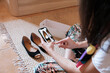 © Malquerida Studio/Stocksy - Anonymous taking photo of shoes for selling online