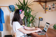 Young Woman Browsing On Laptop At Home