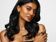 © ohlamour studio/Stocksy - Woman with long wavy black hair close up portrait