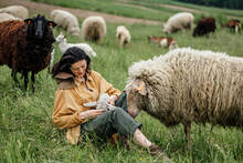 Attractive Joyful Girl Takes Care Of Her Sheep On The Farm