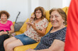 © Raul Navarro/Stocksy - portrait of a family sitting on the sofa