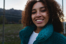 Curly-haired Woman Smiling At The Camera