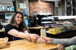 © Alvaro Lavin/Stocksy - Smiling waitress working in bar.