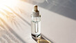 A white transparent bottle with serum in the rays of the sun