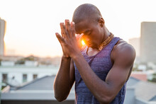 Focused Man In Prayer Hand Pose Meditating With Eyes Closed