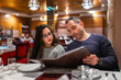 © Lupe Rodríguez/Stocksy - father with daughter eating in restaurant