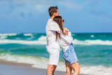 Fototapeta  - Young couple spending time together on the beach