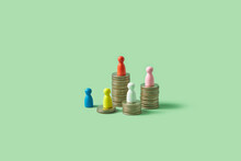 Colorful Game Pawns On Stacks Of Coins.
