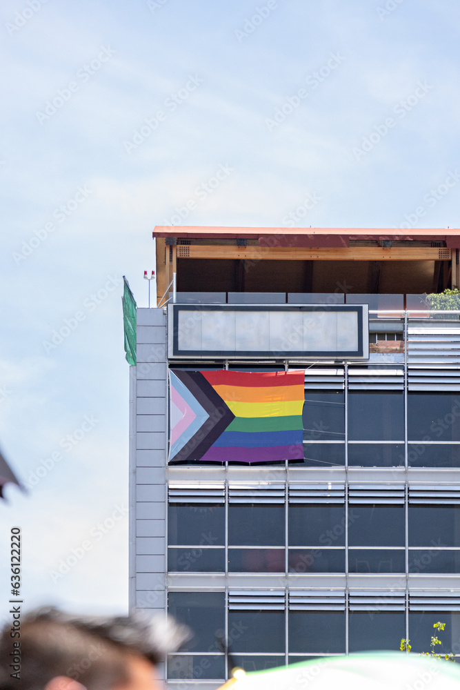 A LGBT+ Flag Hanging In The Upper Corner Of An Office Building Stock ...