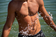 Male Tanned Torso In Water Splash