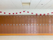 © Raymond Forbes LLC/Stocksy - Wall of Lockers in  Hallway at American High School