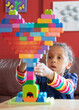 © Anya Brewley Schultheiss/Stocksy - Child building a heart with bright coloured blocks.