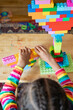 © Anya Brewley Schultheiss/Stocksy - Child building a structure from blocks type blocks