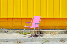Lonely Pink Beach Chair In An Industrial Park