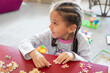© Anya Brewley Schultheiss/Stocksy - Closeup image of a child trying to assemble a puzzle