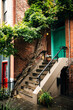 © Yakov Knyazev/Stocksy - Entrance of brick building and tree in city