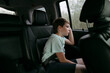 © Irina Polonina/Stocksy - Bored boy in automobile.