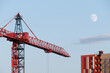 © Ilya/Stocksy - City construction site crane building