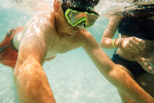 Teenager Swimming Underwater Wearing Goggles. 
